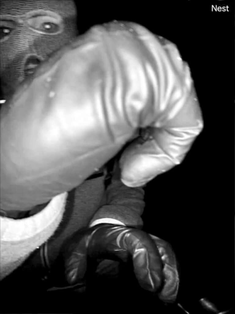 man in mask holds up fist