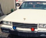 White car with red and blue lights