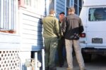 officers speak outside a home