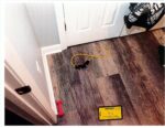 A yellow exercise band is seen on the floor of the Clancy family's basement. (court exhibit)