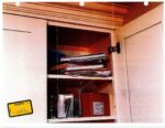 books and notebooks in kitchen cabinet