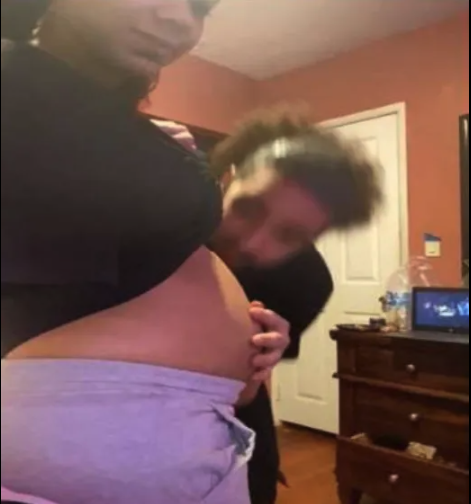 man kisses pregnant stomach