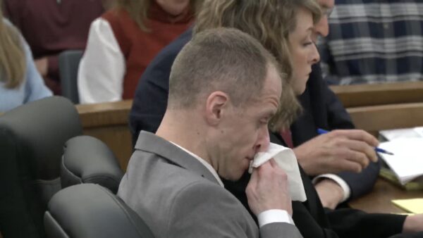 Caleb Flynn wipes his nose in court