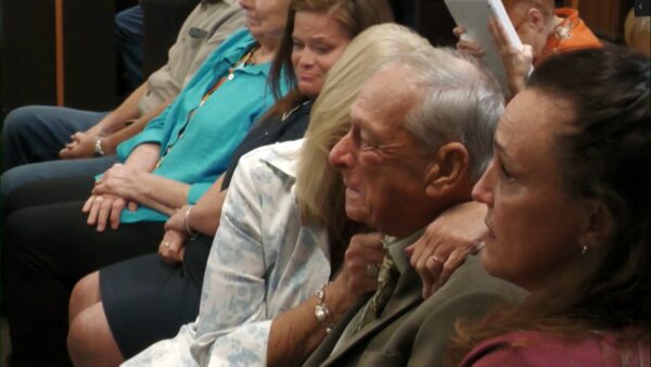 Tim Miller and his wife embrace in the courtroom gallery