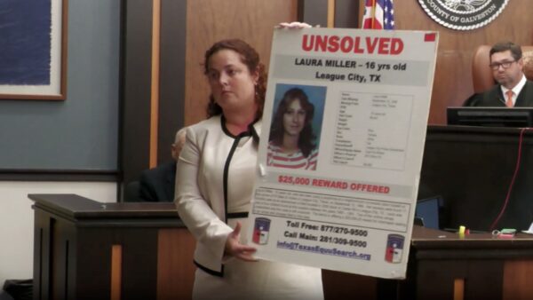 Prosecutor holds up missing person poster