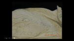 Handwritten note appears written on a white bag (with one word blurred)