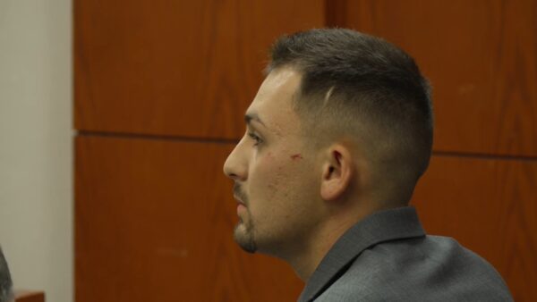 Cooper Ouellette sits in court