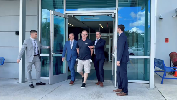 Dale Smith Jr is walked out of police dept